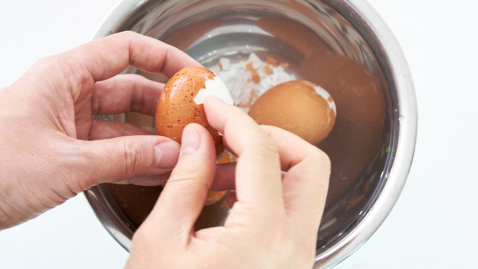 Peeling soft boiled egg to make a Ramen Egg (Ajitsuke Tamago).