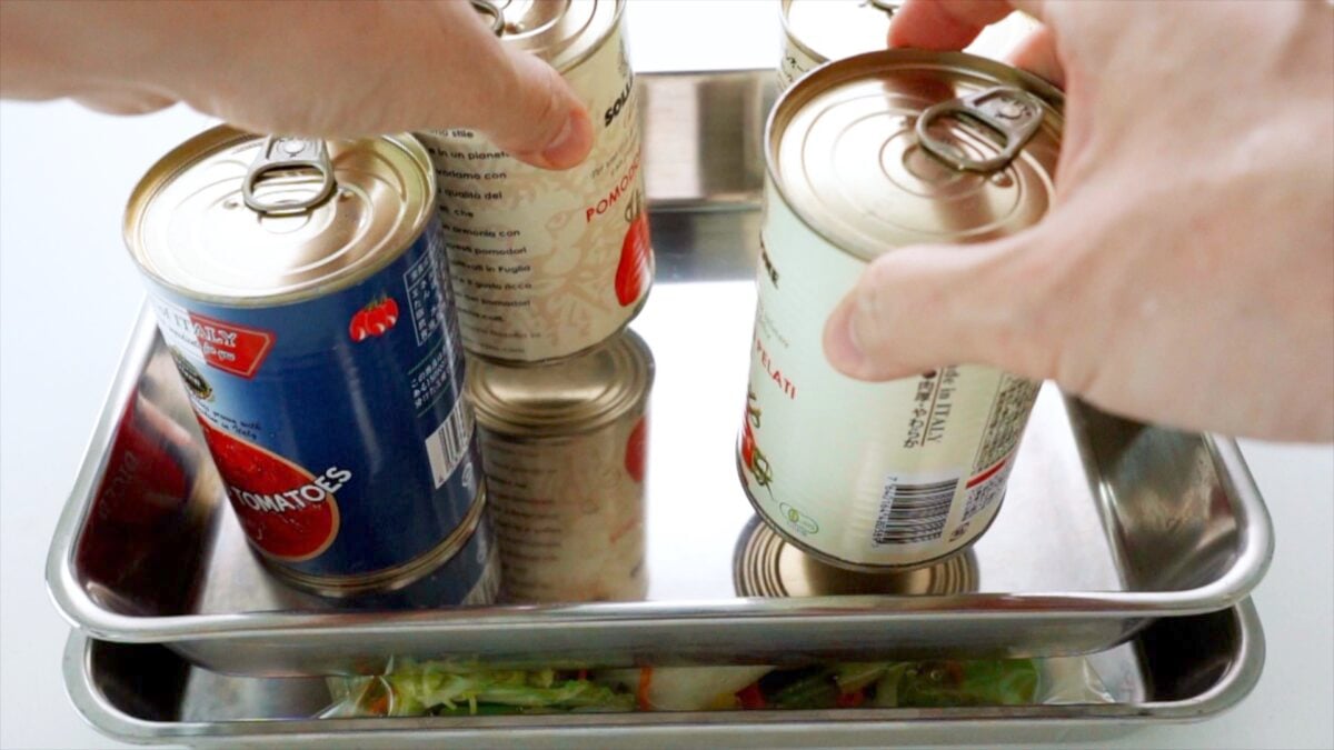 Using cans as weights to press Japanese Tsukemono Pickles.