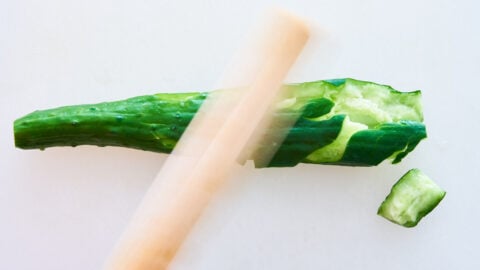 Pounding cucumber with a rolling pin for making bang bang chicken.