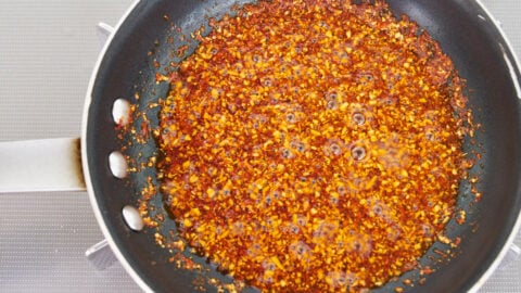 Spicy chili oil in a pan for making bang bang chicken.