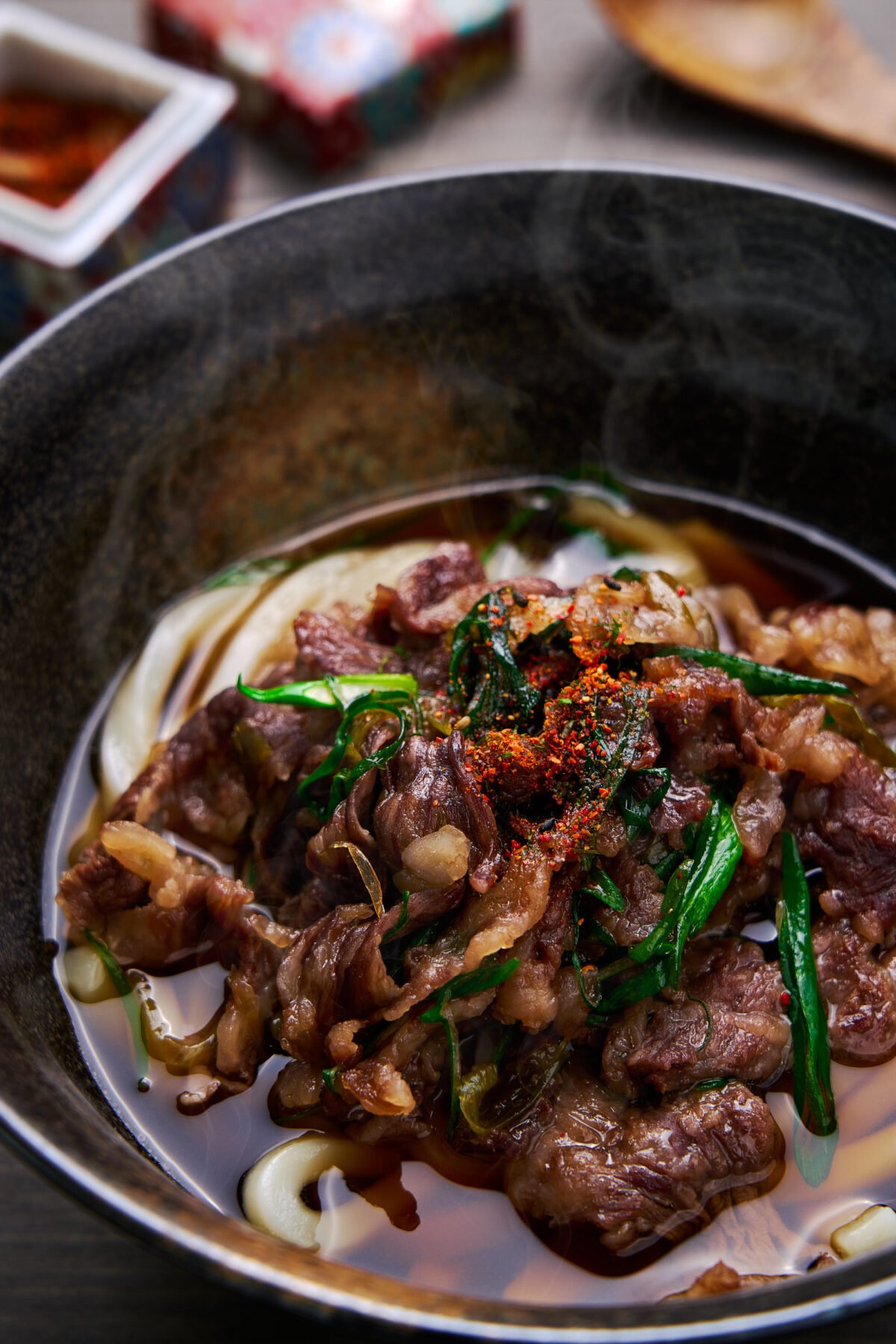 This easy bowl of Niku Udon (Beef Udon) is a comforting bowl of noodle soup topped with tender slices of beef simmered in a savory-sweet sauce with scallions.