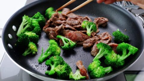 Stir frying broccoli with beef.