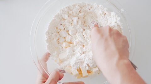 Flaking cold butter into frozen flour for the flakiest pie dough.