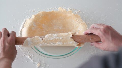 Transferring the bottom crust to a glass pie plate.