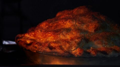 Apple pie baking in a convection oven.