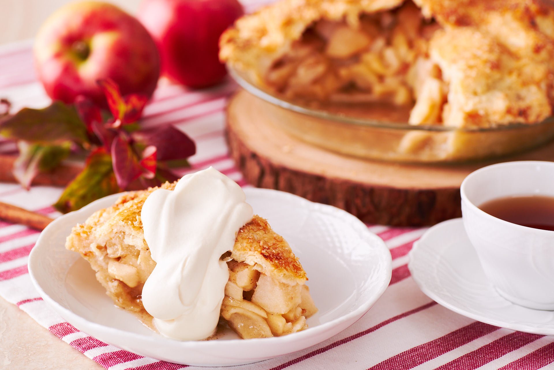 Overstuffed apple pie topped with an ultra-flaky all-butter crust that's studded with crisp crystals of sugar, served with whipped cream.