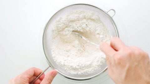 Sifting dry ingredients for banana bread together.