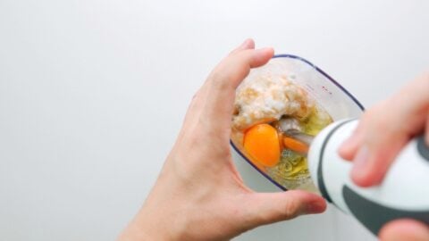 Blending eggs, yogurt and bananas together for banana bread batter.