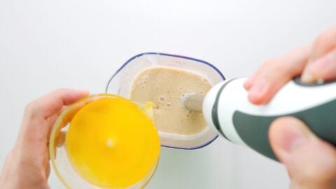 Blending melted butter into banana bread batter.