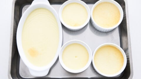 Panna cotta in white ramekins after they have been baked in the oven.