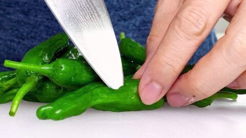 Poking holes in peppers to keep them from popping.