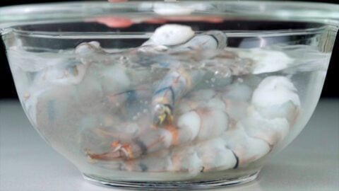 Brining shrimp in alkaline water to improve its texture.