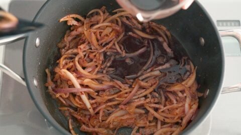 Red onions, Guanciale and pepper flakes being deglazed with red wine.