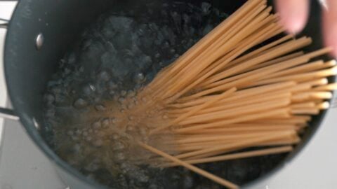 Boiling Bucatini in a pot of salted water.