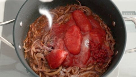 Stewed tomatoes, tomato paste, and salt added to Sugo all'Amatriciana