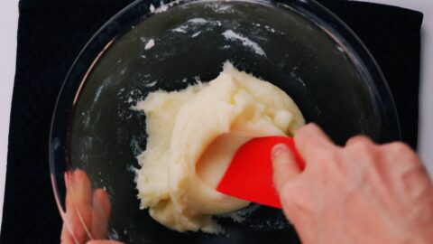 Kneading butter mochi with a spatula.