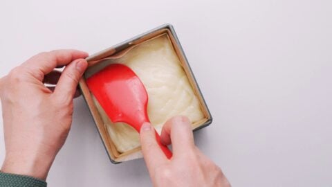 Pressing butter mochi into a mold.