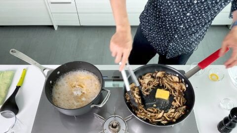 Adding butter to fried mushrooms.