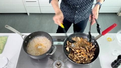 Adding soy sauce to butter and mushrooms.