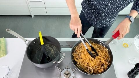 Tossing mushrooms, butter and soy sauce with pasta.