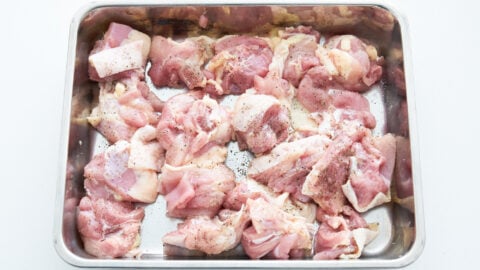 Chicken thighs cut into pieces and sprinkled with salt and pepper for chicken stew.