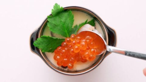 Garnish the chawanmushi with mitsuba, steamed shrimp and Ikura.