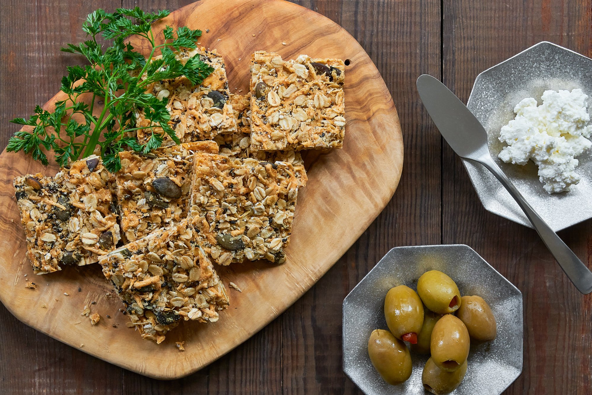 With loads of cheddar and parmesan holding together the oats, chia seeds, pumpkin seeds, and sesame seeds these crisp granola crackers are healthy and delicious.