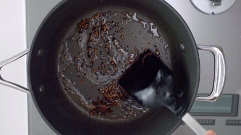 Toasting cumin seeds, nigella seeds, star anise, and cloves for making Chicken Jalfrezi.