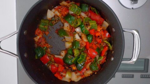 Stir-fried peppers, onions and tomatoes for Chicken Jalfrezi.