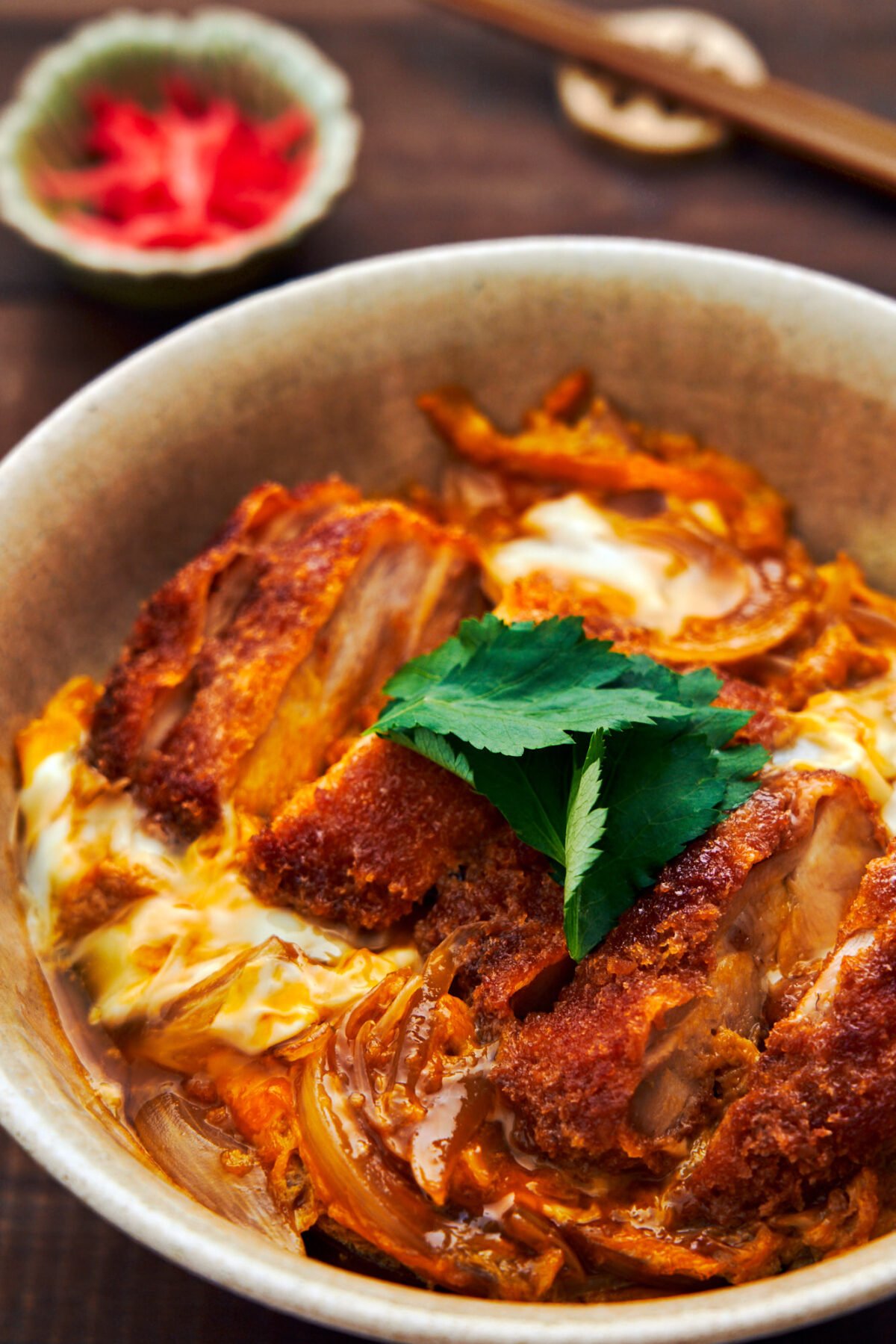 Juicy chicken katsu is simmered in savory-sweet broth with onions and egg, then served over rice in this classic Japanese Katsudon.