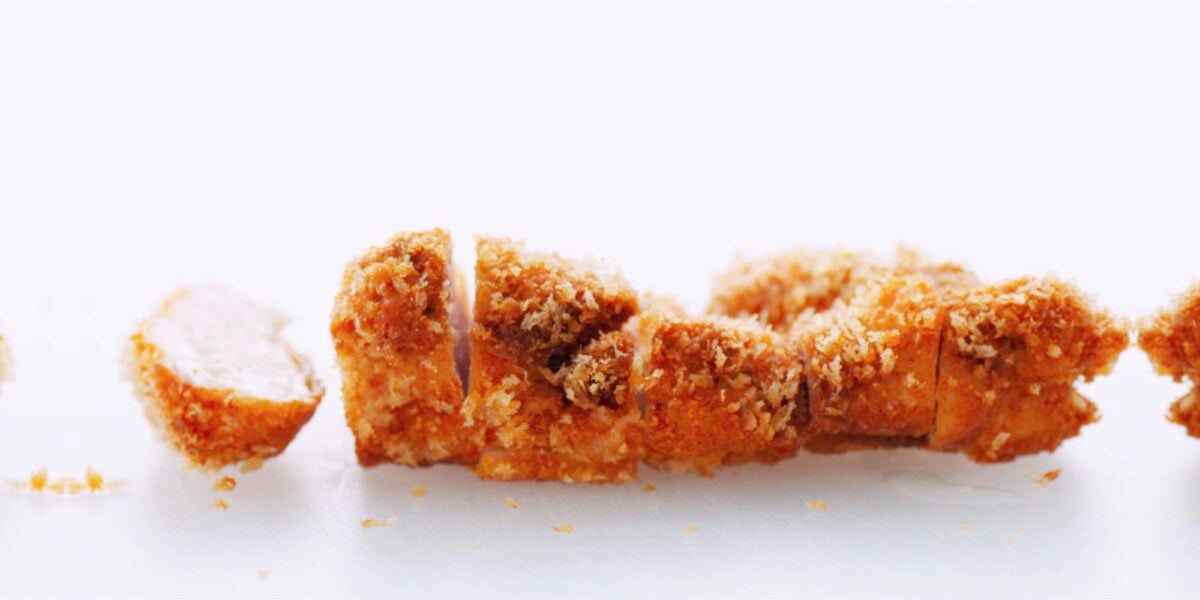 Crispy Chicken Katsu on a white cutting board.