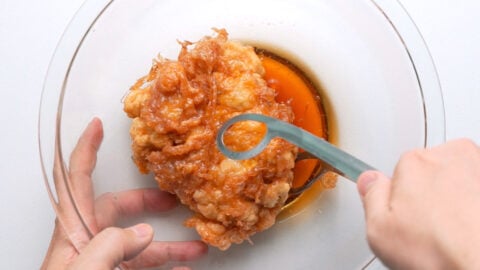 Dipping the fried chicken in Nanban Sauce.