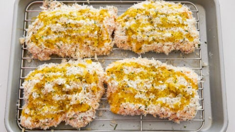 Drizzle the chicken parmesan cutlets with olive oil and bake.