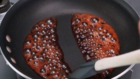 Bubbling teriyaki sauce in a frying pan.