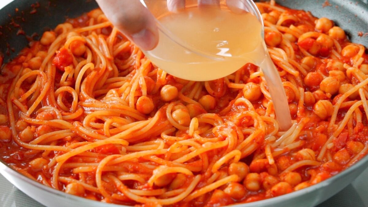 Adding chickpea water to the pasta to keep the sauce from getting too thick.