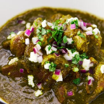 Fork-tender chunks of pork shoulder braised in a tangy sauce made from char-roasted green chiles and tomatillos. Garnished with queso fresco, cilantro and red onions.