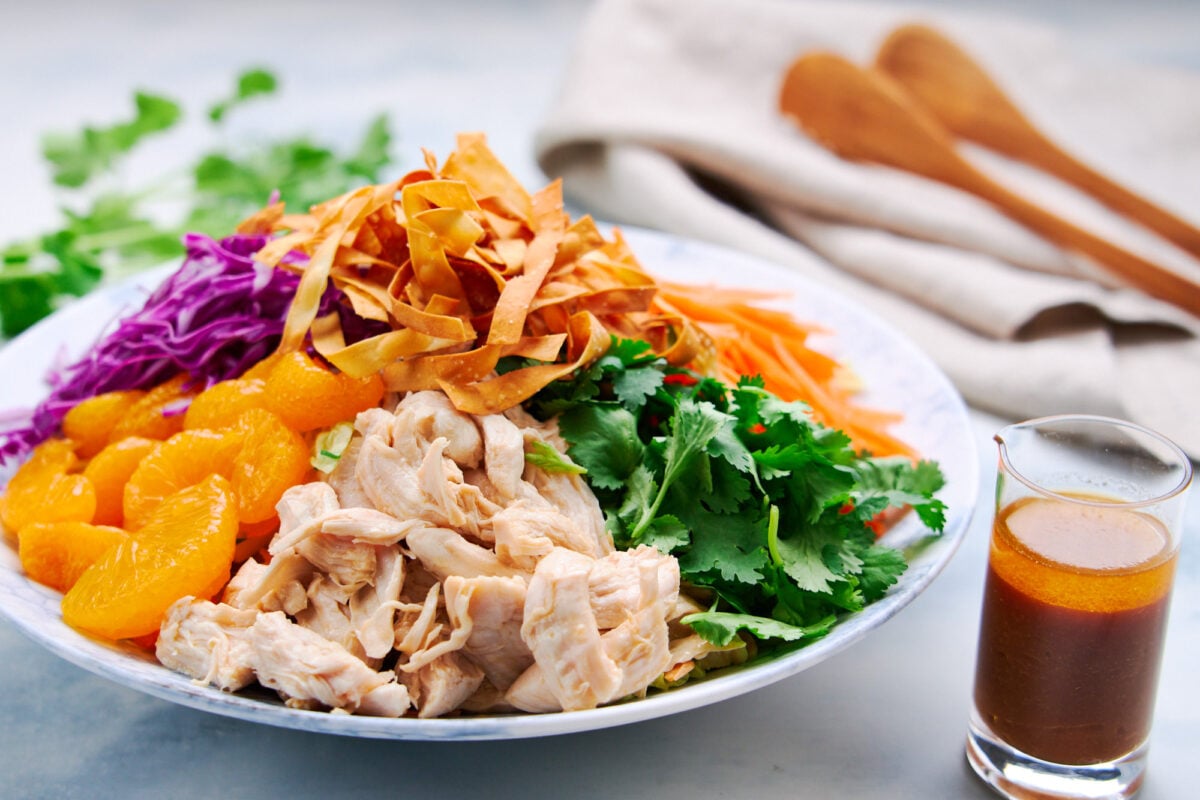 Crave-worthy Chinese chicken salad recipe topped with juicy shredded chicken, mandarins, crispy wontons, carrots and cabbage.