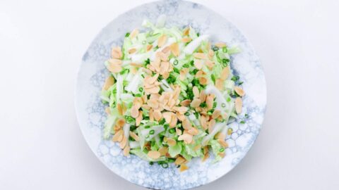 Shredded napa cabbage topped with toasted almonds and scallions.