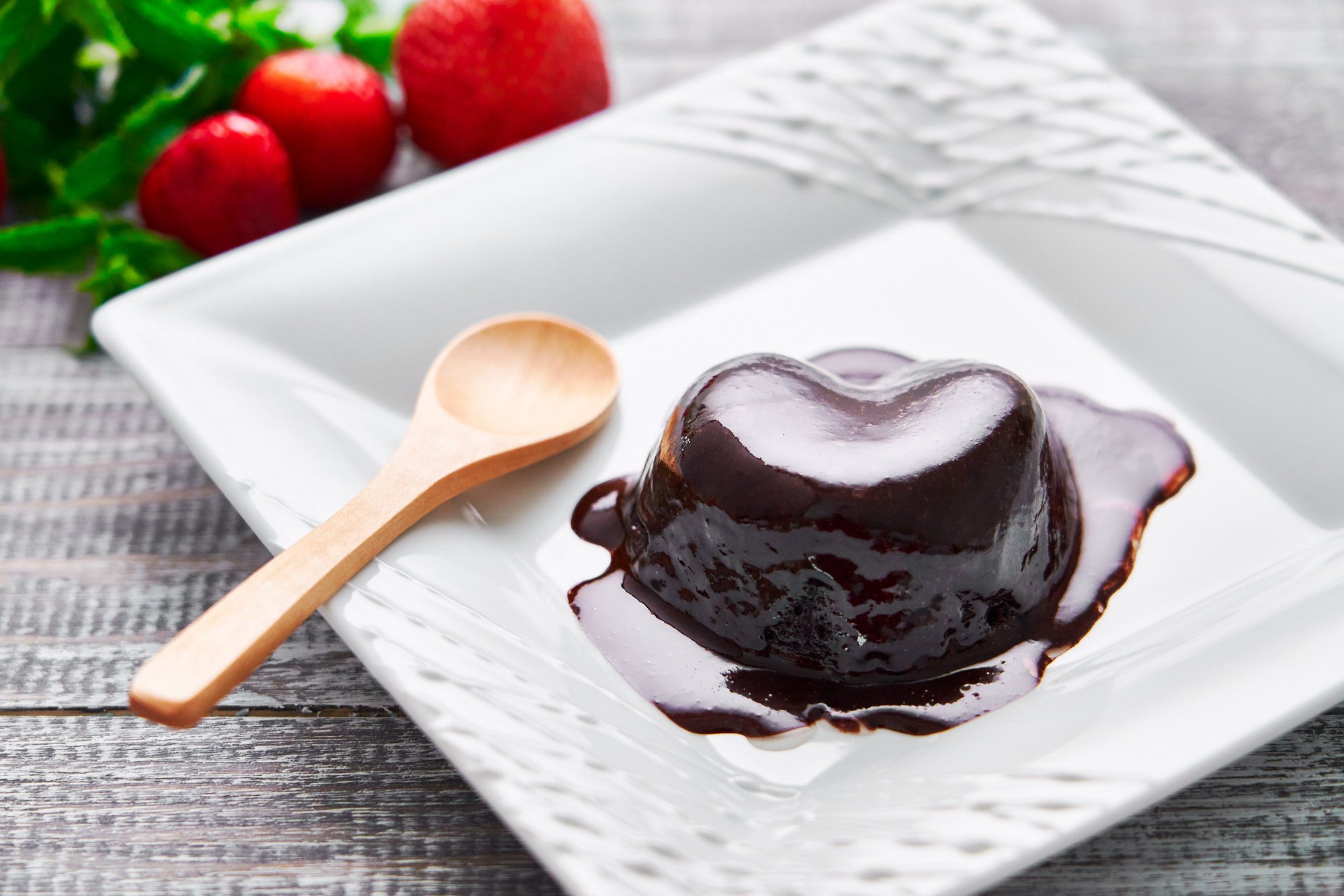 Easy chocolate mug cake that can be made in the microwave in about a minute is coated in gooey chocolate sauce.