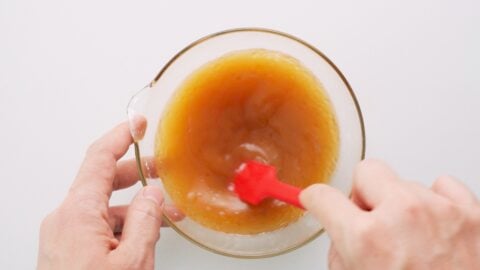 Mixing sauce for Chop Suey in a glass bowl.