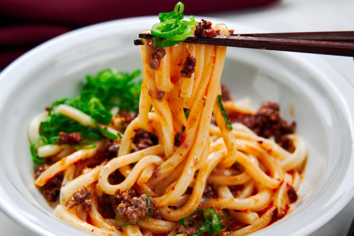 Cold udon noodles in a creamy sesame broth topped with spicy chili oil and beef.