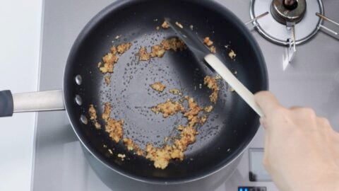 Ground Sichuan pepper and sugar in a frying pan.