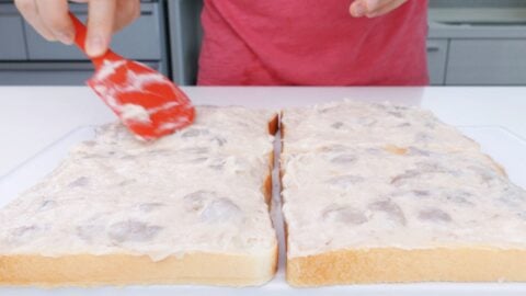 Spreading shrimp paste on sandwich bread.