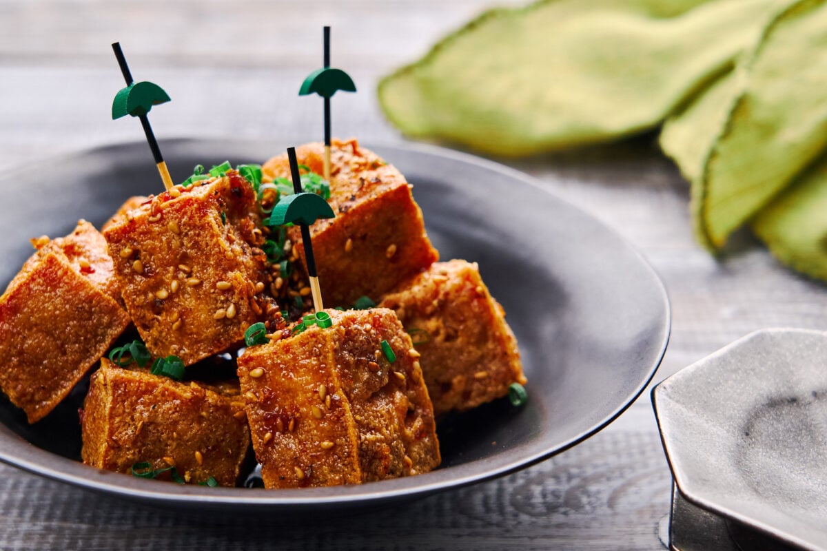 Shatteringly crisp cubes of tofu glazed in a savory-sweet ginger, garlic and black pepper sauce. A delicious plant-based canape.