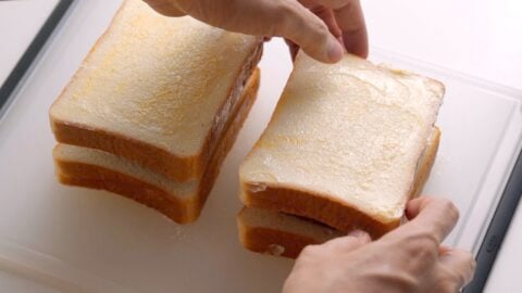 Topping the curry bread off with another slice of buttered bread.