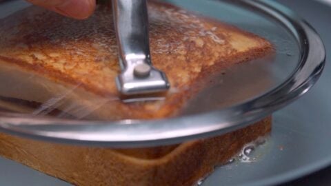 Grilled curry bread under a glass drop lid.