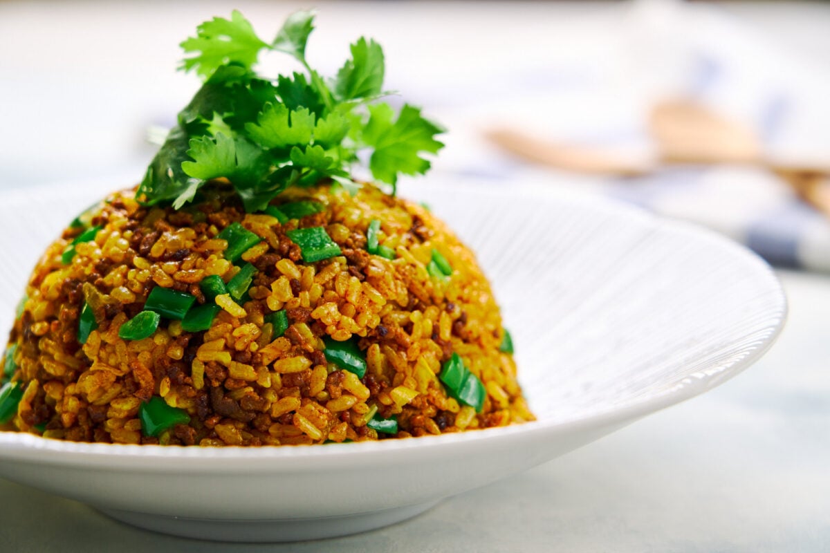 A mound of Japanese curry fried rice (Curry Chahan) topped with cilantro.