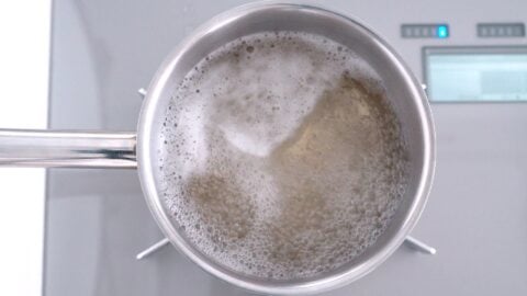 Konbu dashi boiling in a stainless steel pot.