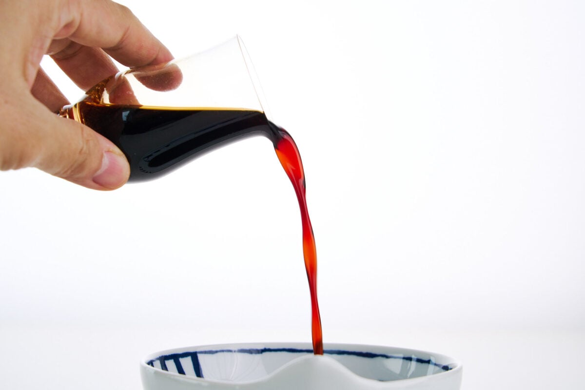 Pouring Japanese seasoning soy sauce into a bowl.