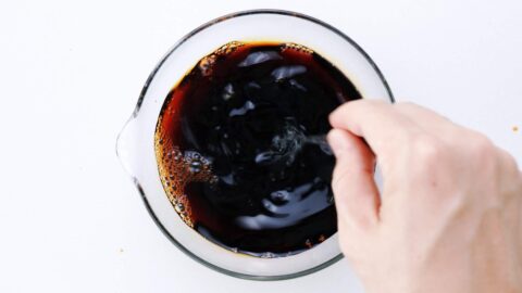 Mixing sugar and soy sauce together.